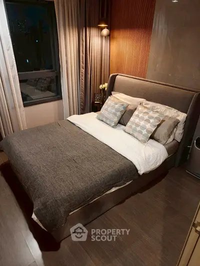 Cozy modern bedroom with stylish decor and large window view