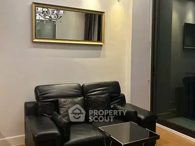 Modern living room with black leather sofa and elegant mirror decor