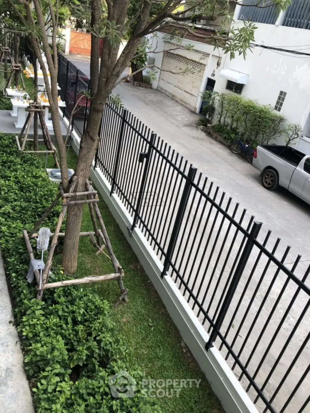 Charming garden view with lush greenery and secure fencing in a peaceful neighborhood setting.