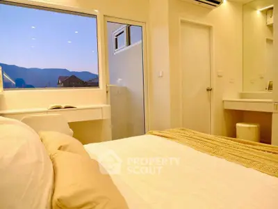 Cozy bedroom with mountain view, featuring a comfortable bed and elegant decor.