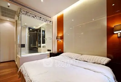 Luxurious bedroom with modern ensuite bathroom and elegant lighting.