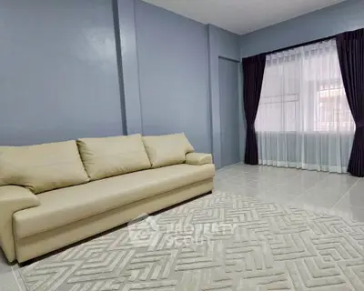 Spacious living room with modern sofa and elegant curtains