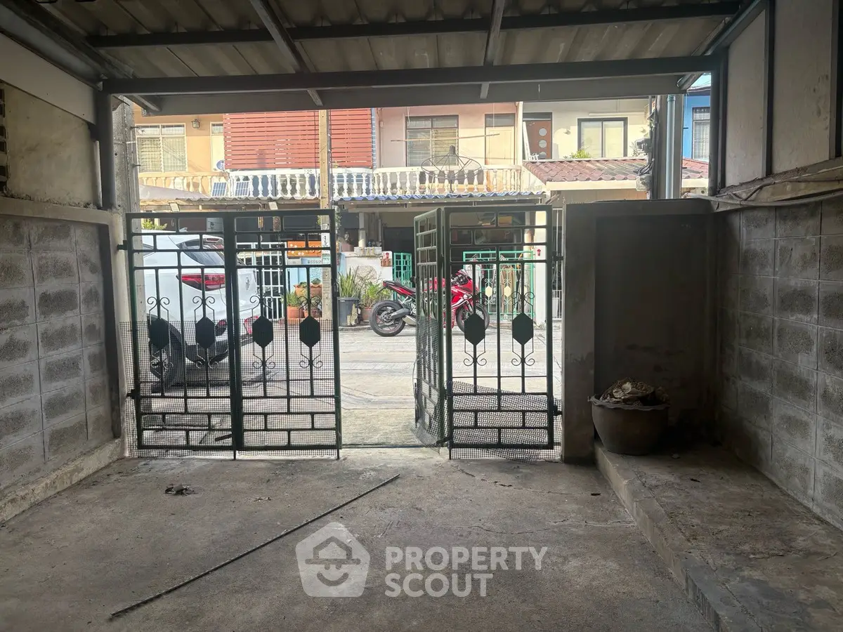 Spacious garage with metal gate and street view, ideal for secure parking or storage.