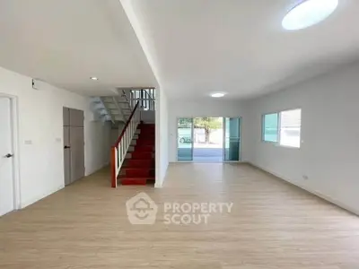 Spacious modern living room with wooden flooring and staircase