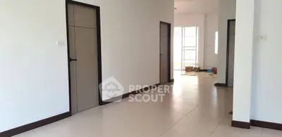 Spacious hallway with multiple doors and natural light in modern home