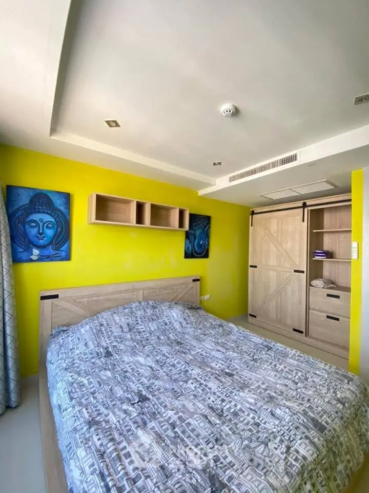 Bright bedroom with modern decor and vibrant yellow accent wall
