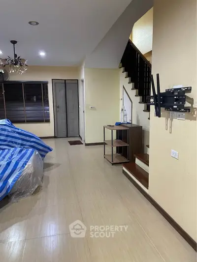 Spacious living room with staircase and modern decor in a stylish home