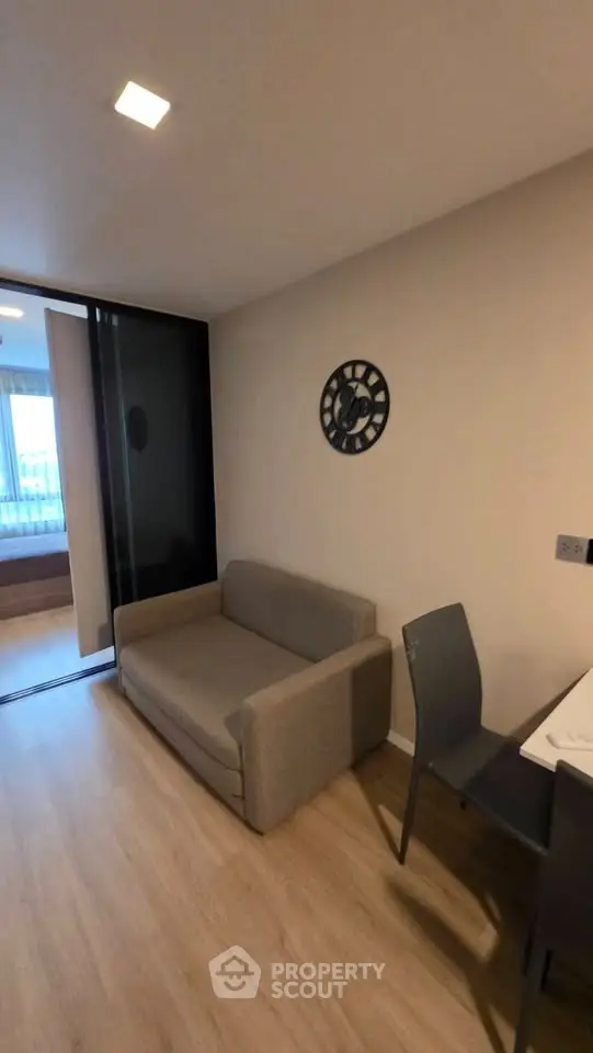 Modern living room with cozy sofa and stylish decor in a contemporary apartment.