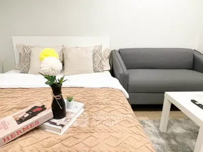 Cozy bedroom with stylish decor and comfortable seating area