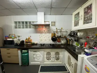 Charming kitchen with gas stove and ample storage, perfect for culinary enthusiasts.