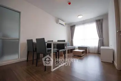 Modern living room with sleek furniture and large window for natural light