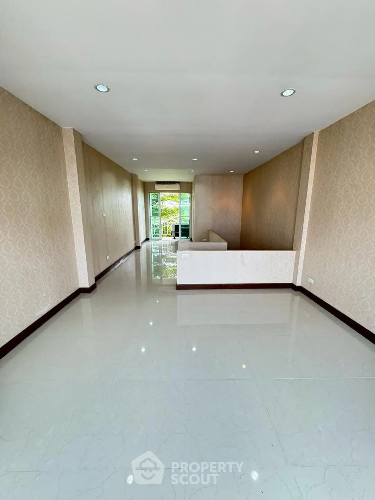Spacious and bright interior with elegant wallpaper and glossy flooring, ideal for modern living.