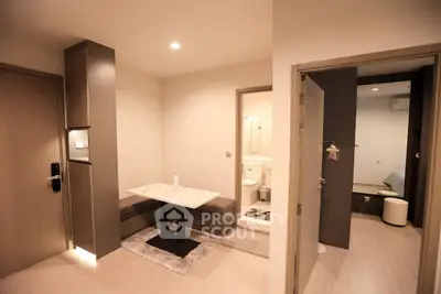 Modern apartment interior with cozy dining area and view into bedroom and bathroom.