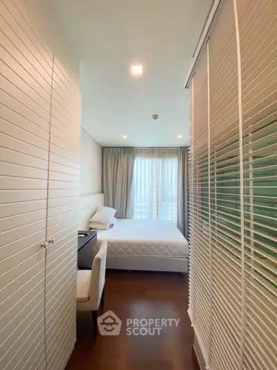 Cozy bedroom with modern decor and ample natural light