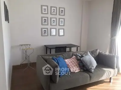 Cozy living room with modern sofa and wall art, perfect for relaxation.