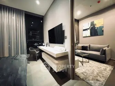 Modern apartment interior with stylish living room and bedroom, featuring sleek furniture and contemporary decor.