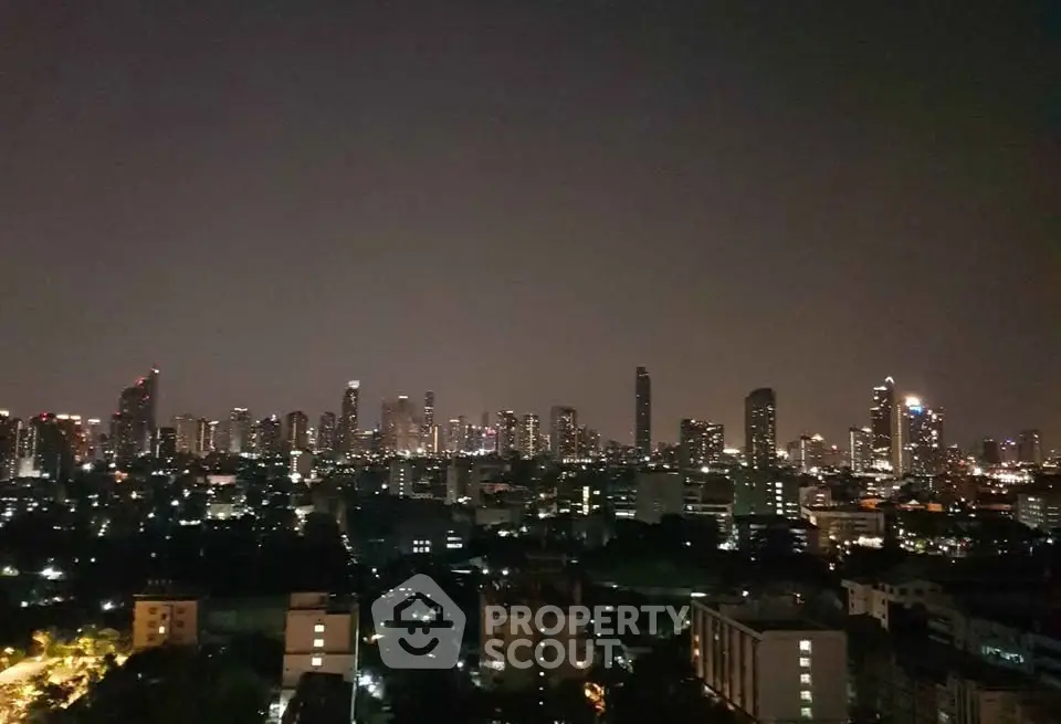 Stunning city skyline view at night showcasing urban high-rise buildings and vibrant city lights.