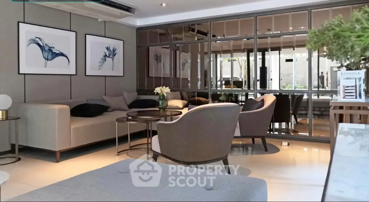 Elegant living room with modern decor and stylish furniture, featuring large mirrors and contemporary artwork.
