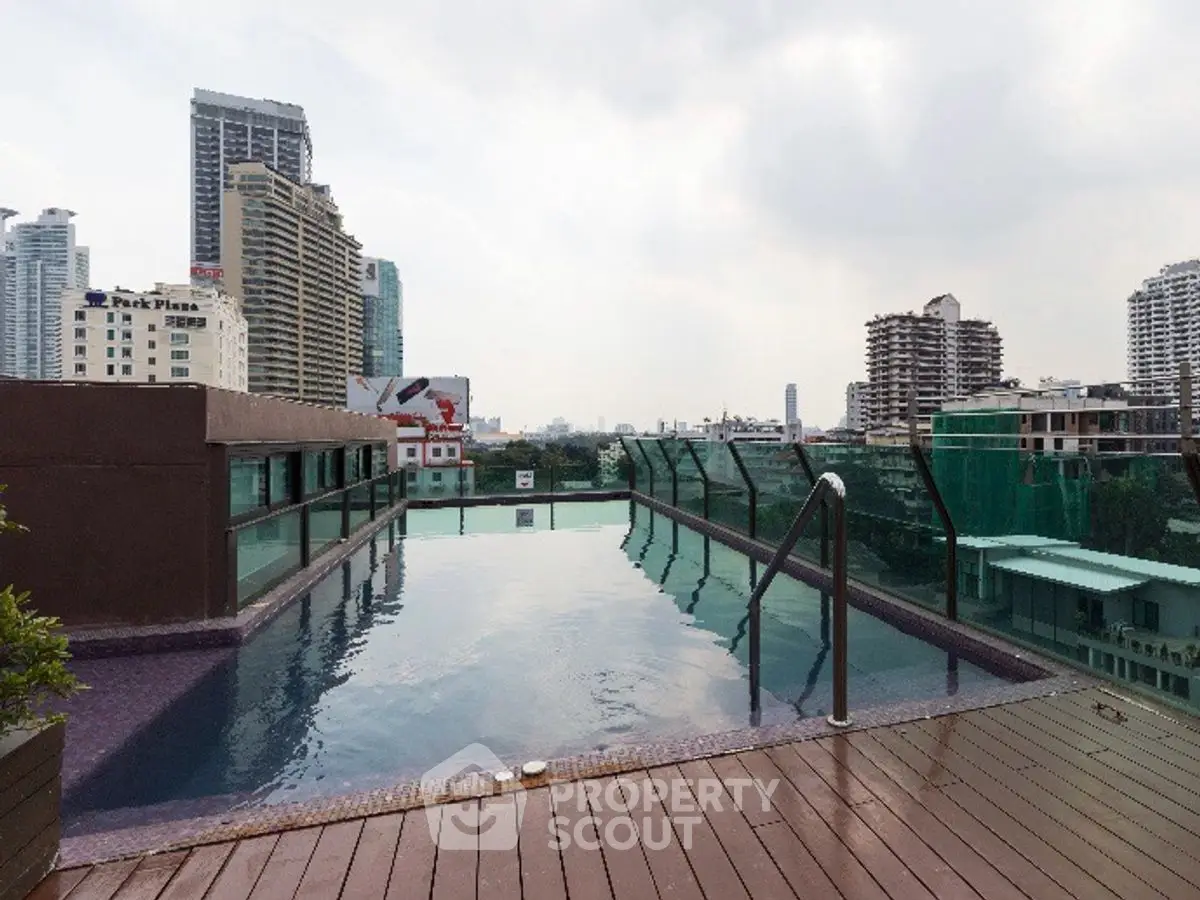 Luxurious rooftop pool with stunning city skyline views, perfect for relaxation and leisure.