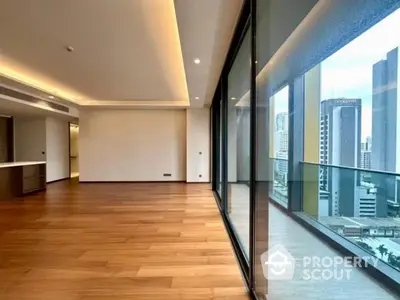 Spacious modern living room with floor-to-ceiling windows and city view