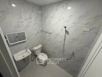 Modern bathroom with sleek marble tiles and minimalist fixtures