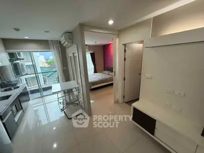 Modern apartment interior with open kitchen and balcony view