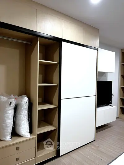 Modern bedroom with built-in wardrobe and sleek TV unit