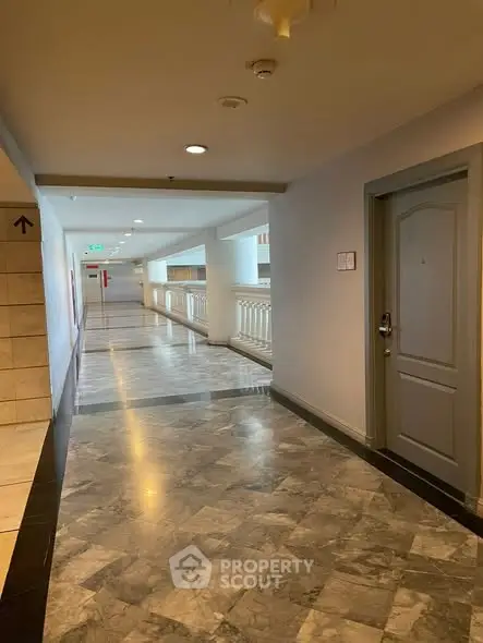 Spacious apartment corridor with elegant marble flooring and modern design.
