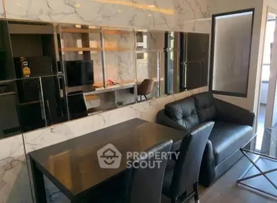 Modern living room with marble walls and sleek black furniture
