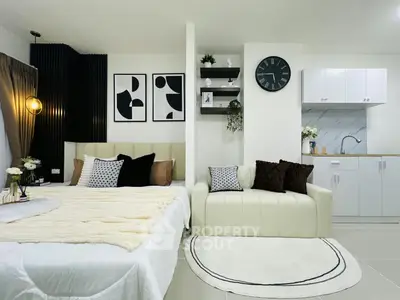 Modern studio apartment with stylish decor and compact kitchen area