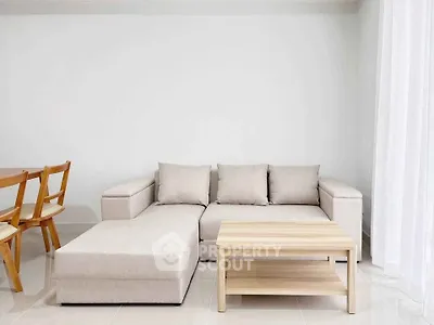 Modern living room with beige sectional sofa and wooden coffee table, perfect for cozy gatherings.