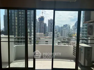 Spacious balcony with stunning city skyline view, perfect for urban living.