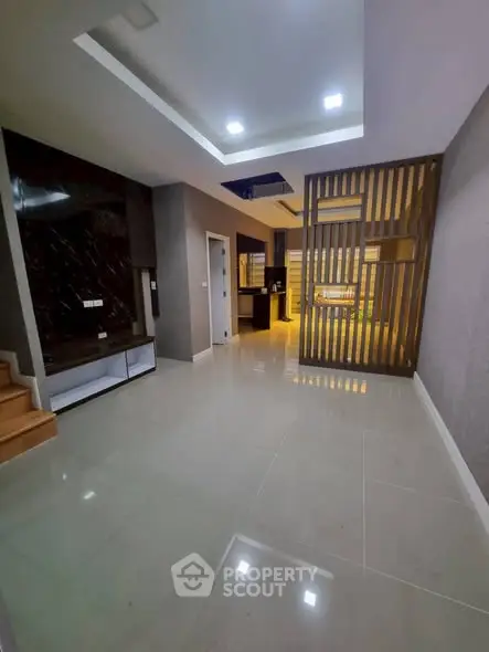 Modern open-plan living area with sleek design and ambient lighting