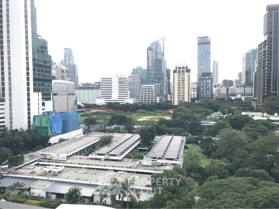 Stunning cityscape view with lush greenery and modern skyscrapers.
