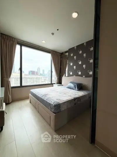 Modern bedroom with city view and stylish decor in high-rise apartment