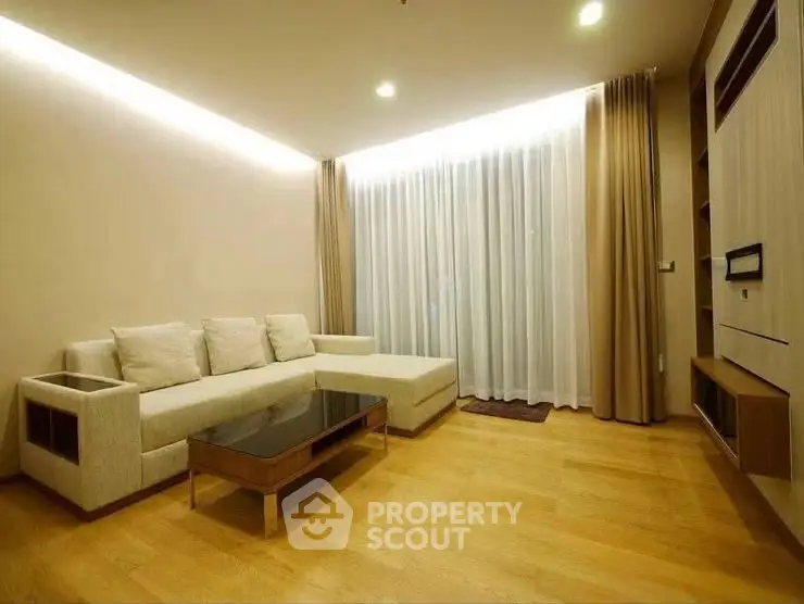 Spacious modern living room with elegant wooden flooring and cozy sofa