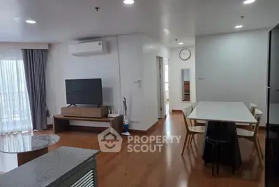 Modern living room with dining area and large window for natural light.