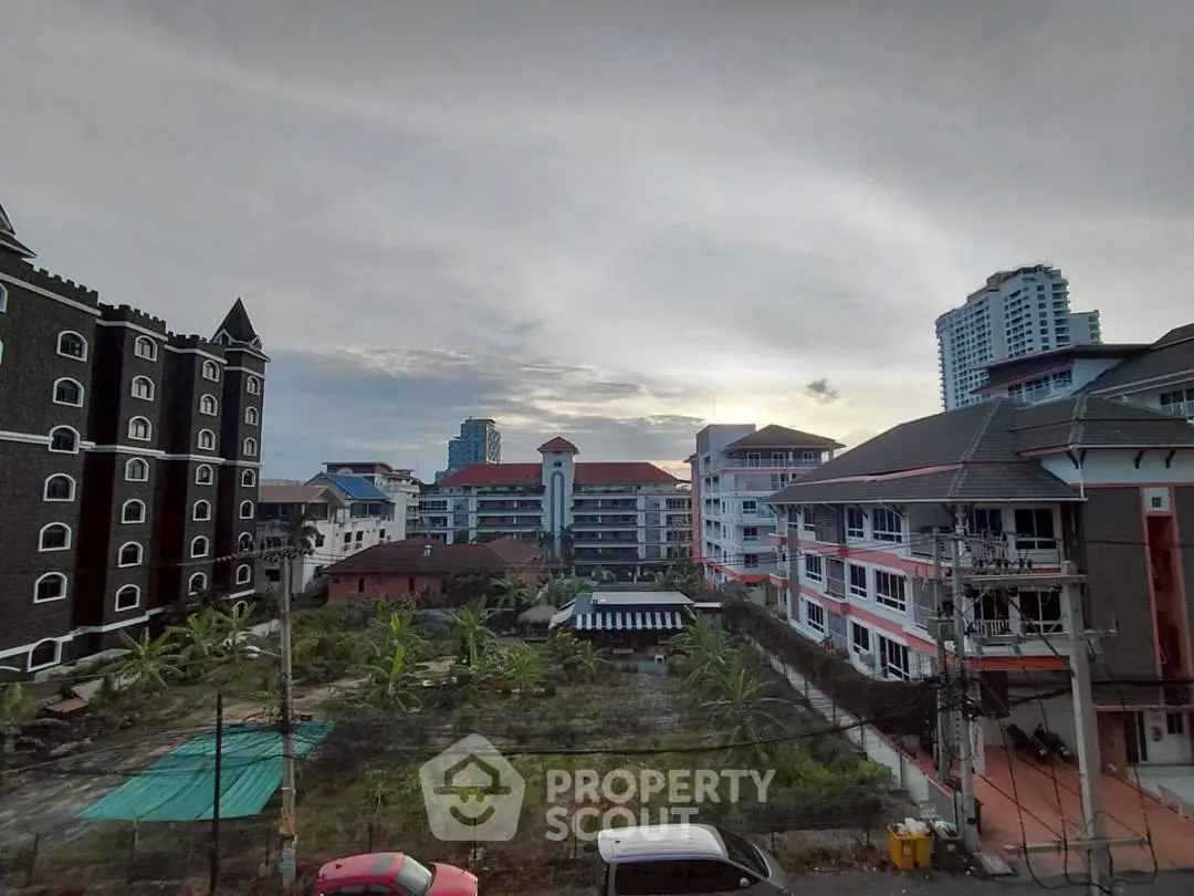 Scenic view of urban residential buildings with lush greenery and clear sky