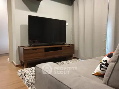 Modern living room with sleek TV setup and cozy gray sofa