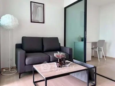 Modern living room with sleek sofa and stylish decor, featuring a cozy study nook.