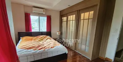 Spacious bedroom with wooden flooring and large closet in modern home