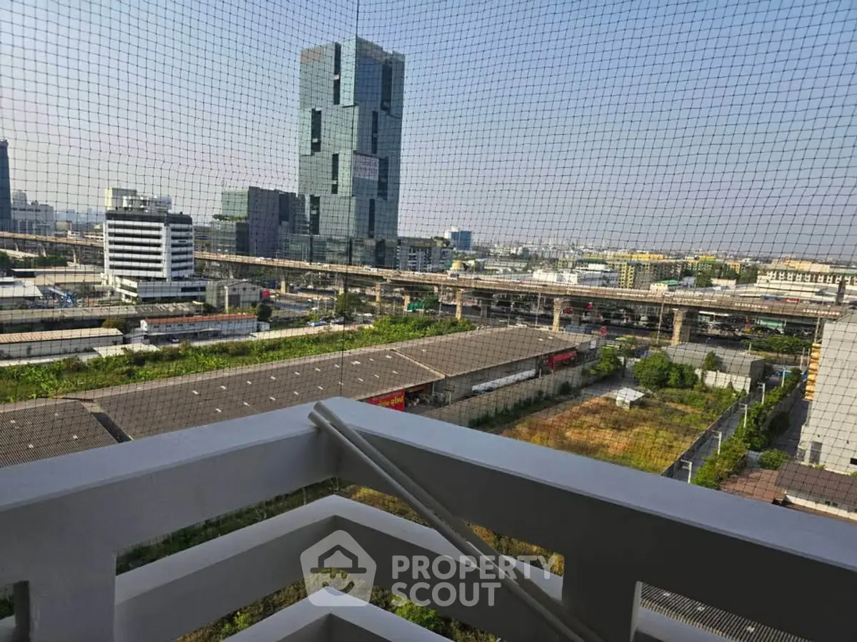 Stunning cityscape view from a high-rise balcony with modern architecture.