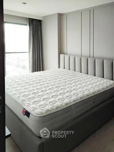 Modern bedroom with large window and stylish bed in high-rise apartment