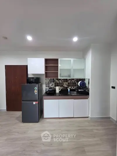 Modern kitchen with sleek cabinetry and appliances in a stylish apartment.
