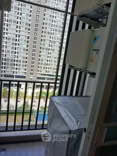 High-rise apartment balcony with city view and laundry area