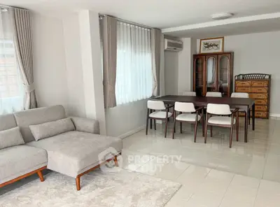 Spacious living room with elegant dining area and modern furniture