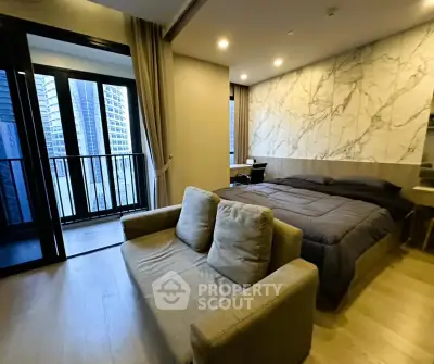 Luxurious bedroom with modern decor and city view balcony in high-rise apartment.