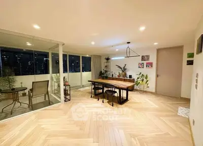 Spacious modern living room with elegant dining area and balcony view.