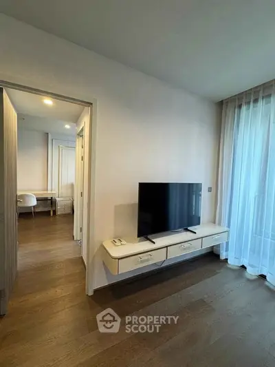 Modern living room with sleek TV stand and hardwood floors