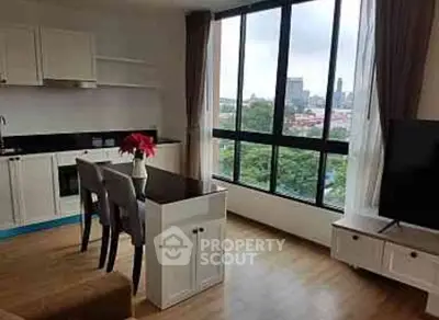 Modern living room with city view and open kitchen layout